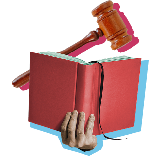 A hand holding a red book with a gavel above it